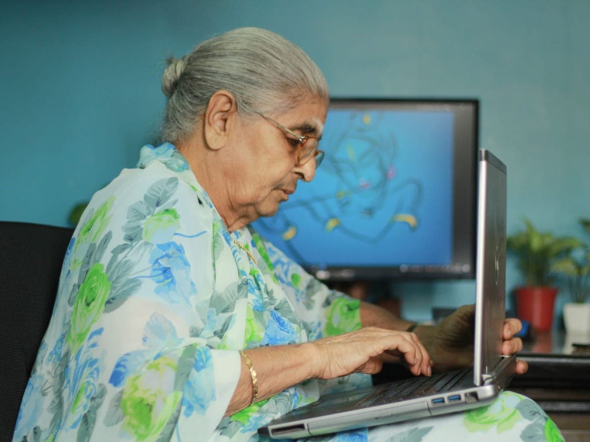 Elderly woman using a laptop at home